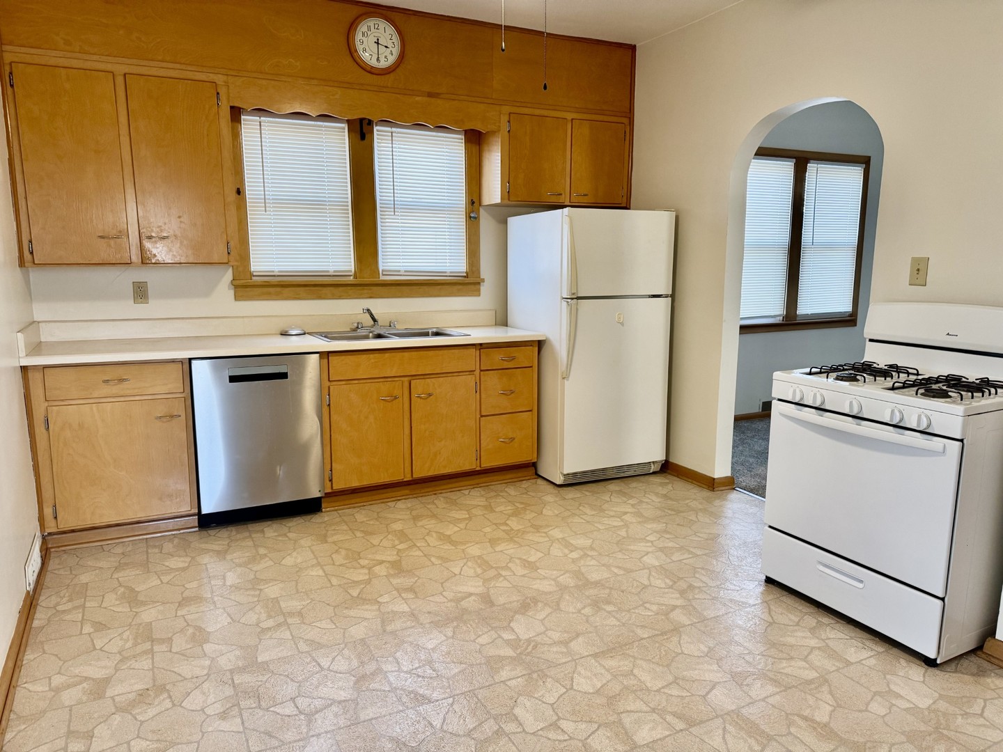 102 West 3rd Street Oglesby, IL 61348 - Photo 11 of 12 a kitchen with stainless steel appliances a refrigerator sink and cabinets