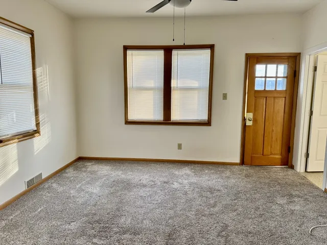 an empty room with windows and closet