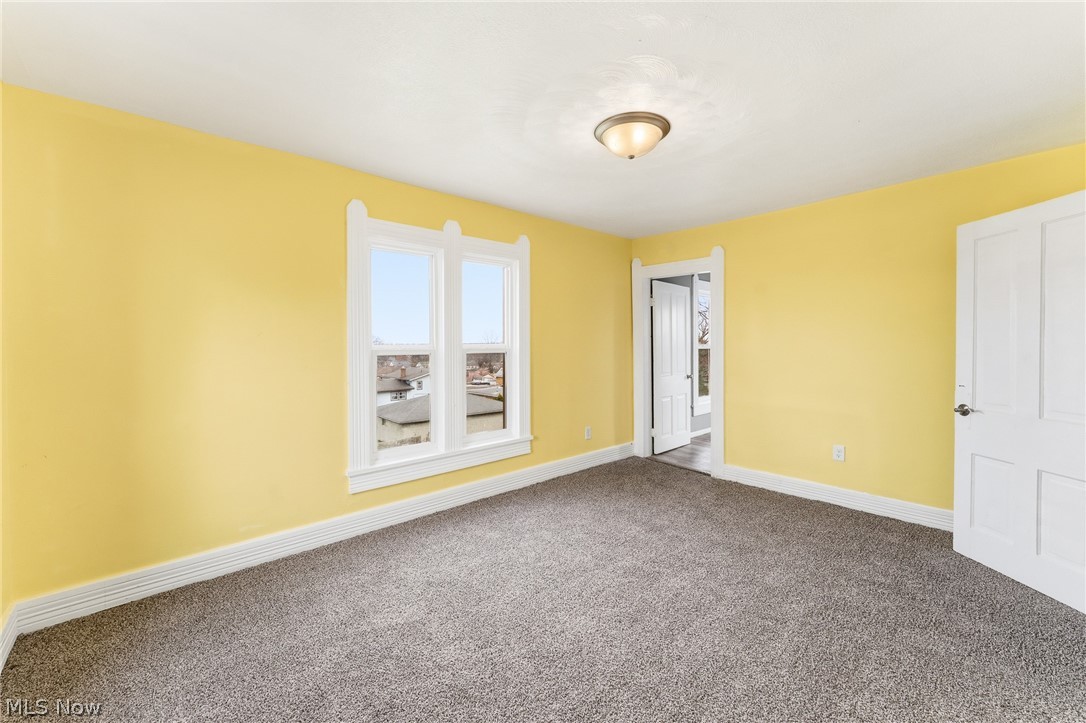 563 Geneva Avenue Struthers, OH 44471 - Photo 17 of 31 Unfurnished bedroom featuring baseboards and dark colored carpet