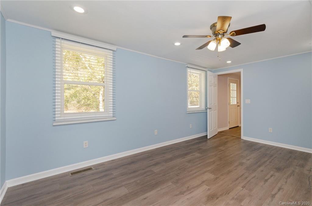 71 Jones Road Leicester, NC 28748 - Photo 16 of 20 a view of an empty room with wooden floor and a window