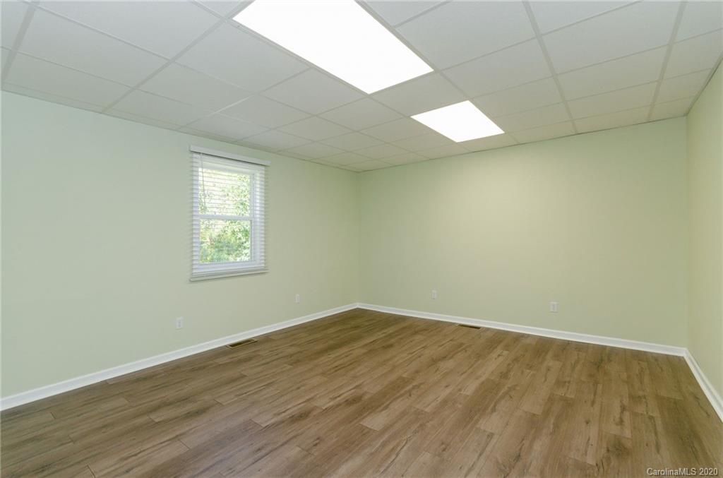 71 Jones Road Leicester, NC 28748 - Photo 17 of 20 an empty room with wooden floor and windows