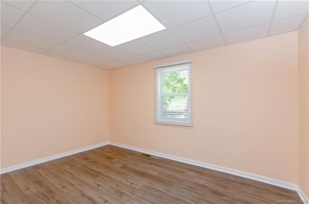 71 Jones Road Leicester, NC 28748 - Photo 18 of 20 an empty room with wooden floor and windows