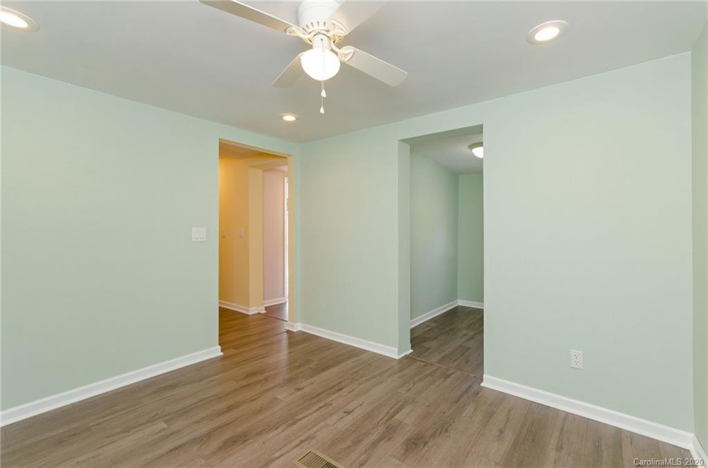 71 Jones Road Leicester, NC 28748 - Photo 7 of 20 an empty room with wooden floor and fan