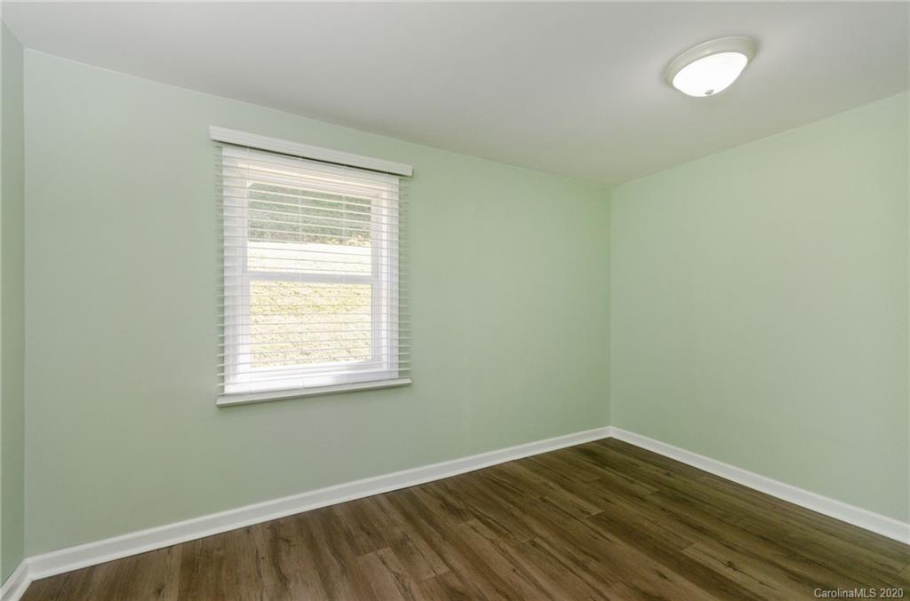 71 Jones Road Leicester, NC 28748 - Photo 8 of 20 an empty room with wooden floor and windows