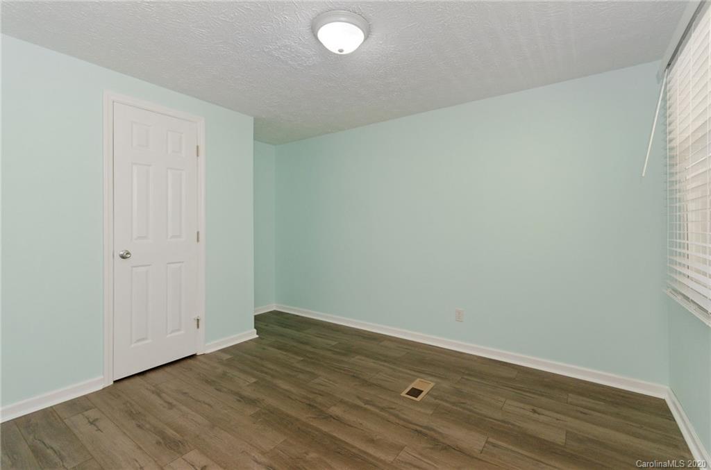 71 Jones Road Leicester, NC 28748 - Photo 9 of 20 an empty room with wooden floor and windows