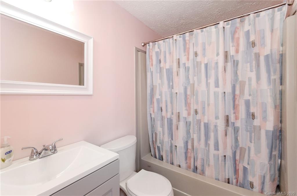 71 Jones Road Leicester, NC 28748 - Photo 10 of 20 a bathroom with a sink a toilet and shower curtain