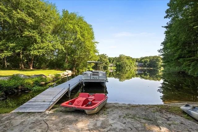 a view of a backyard with lawn chairs and a fire pit