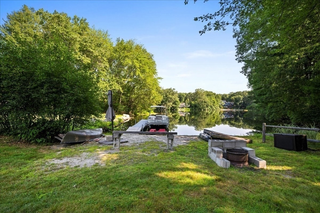 14 Elizabeth Street Dudley, MA 01571 - Photo 2 of 37 a view of a backyard with lawn chairs and a fire pit