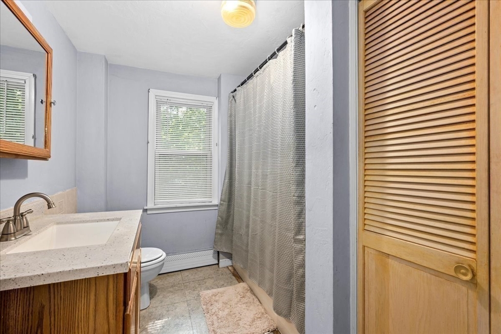 14 Elizabeth Street Dudley, MA 01571 - Photo 28 of 37 a bathroom with a sink a toilet and shower