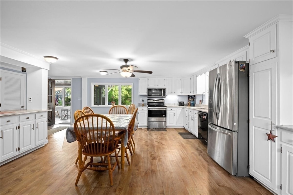 14 Elizabeth Street Dudley, MA 01571 - Photo 9 of 37 a kitchen with stainless steel appliances granite countertop a refrigerator a sink a stove a dining table and chairs