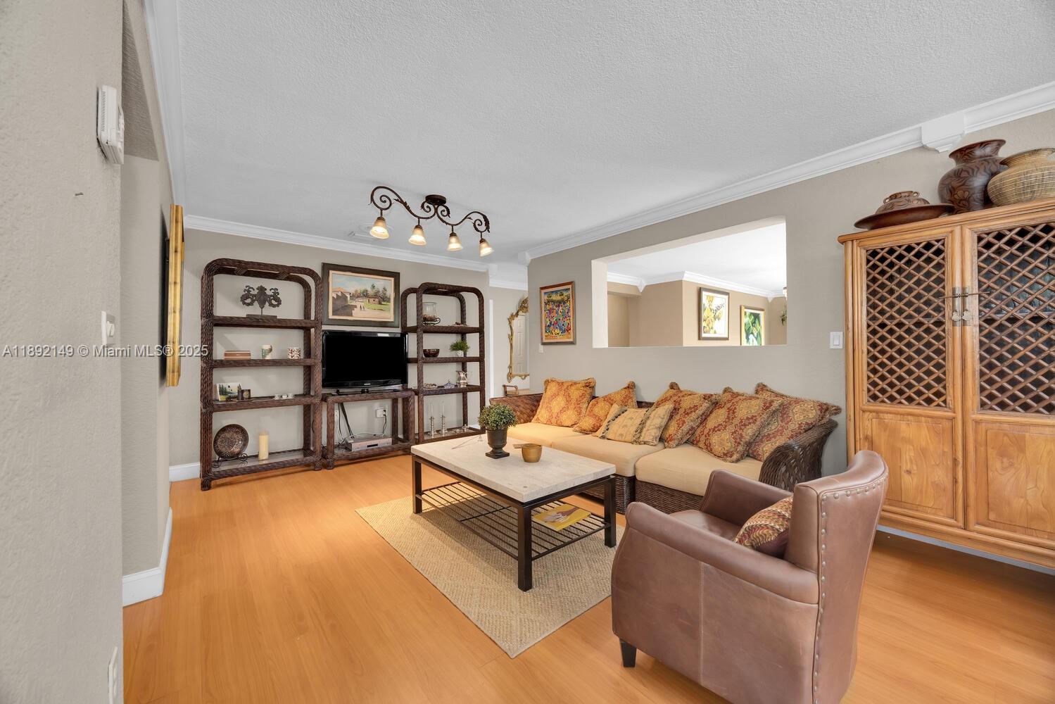 825 El Rado Street Coral Gables, FL 33134 - Photo 11 of 40 a living room with furniture and a flat screen tv