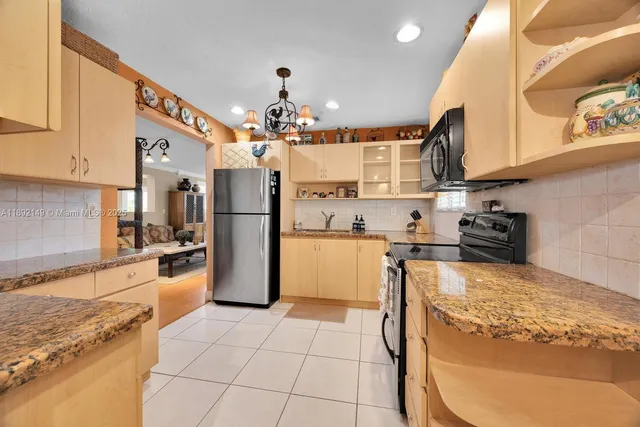 a kitchen with refrigerator and cabinets