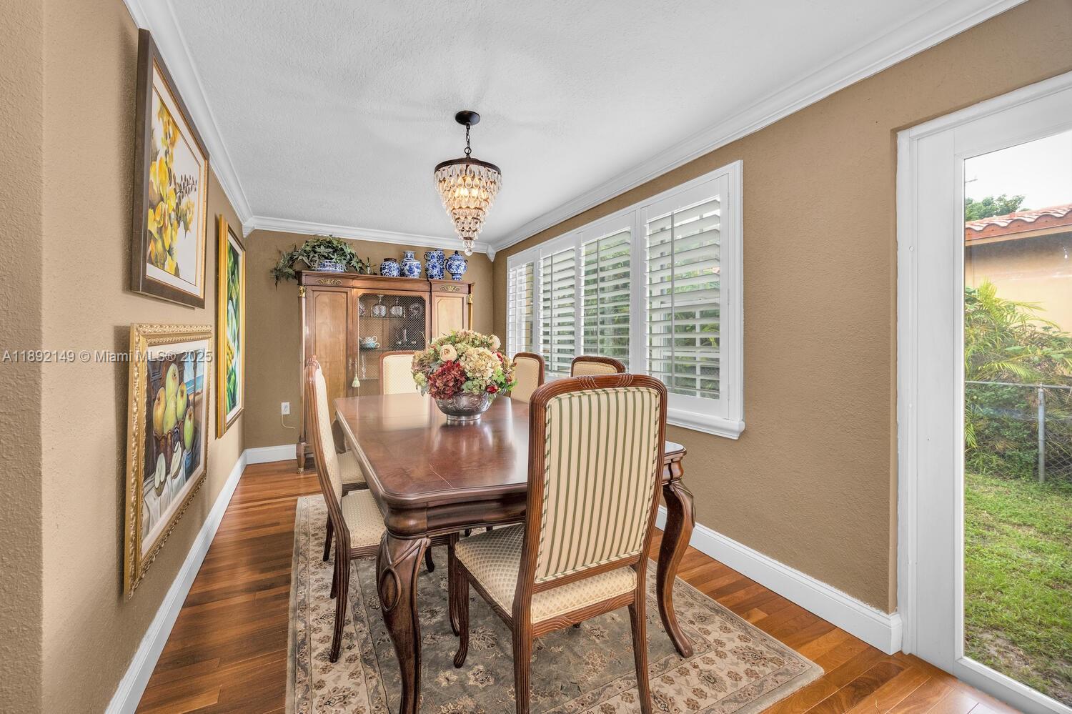 825 El Rado Street Coral Gables, FL 33134 - Photo 20 of 40 a view of a dining room with furniture window and wooden floor