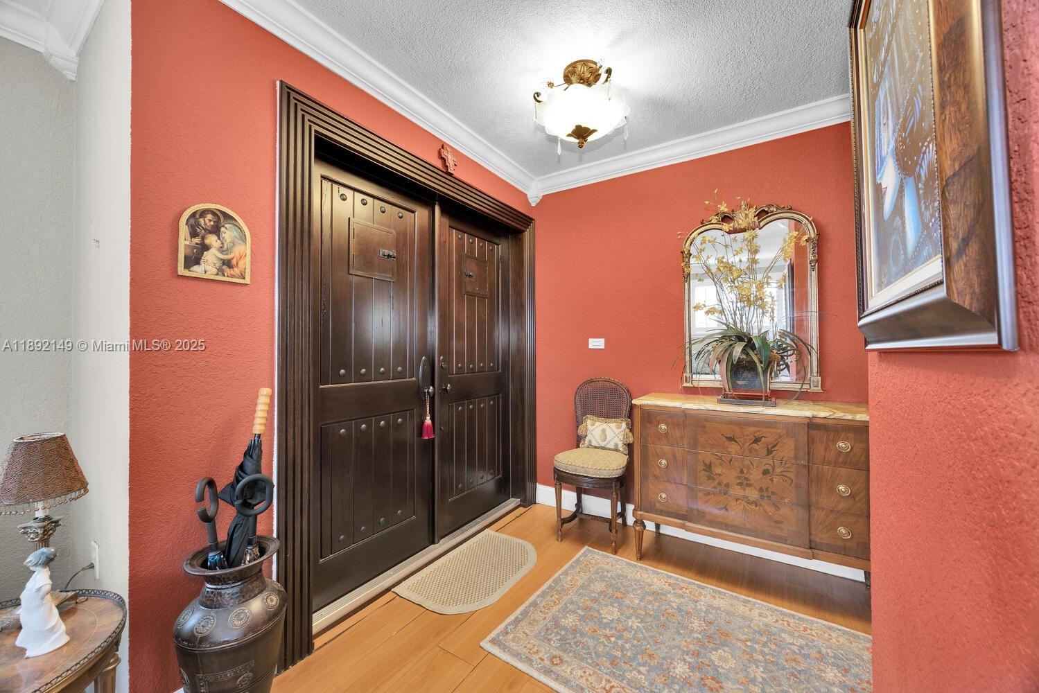 825 El Rado Street Coral Gables, FL 33134 - Photo 2 of 40 a living room with a couch and a chandelier