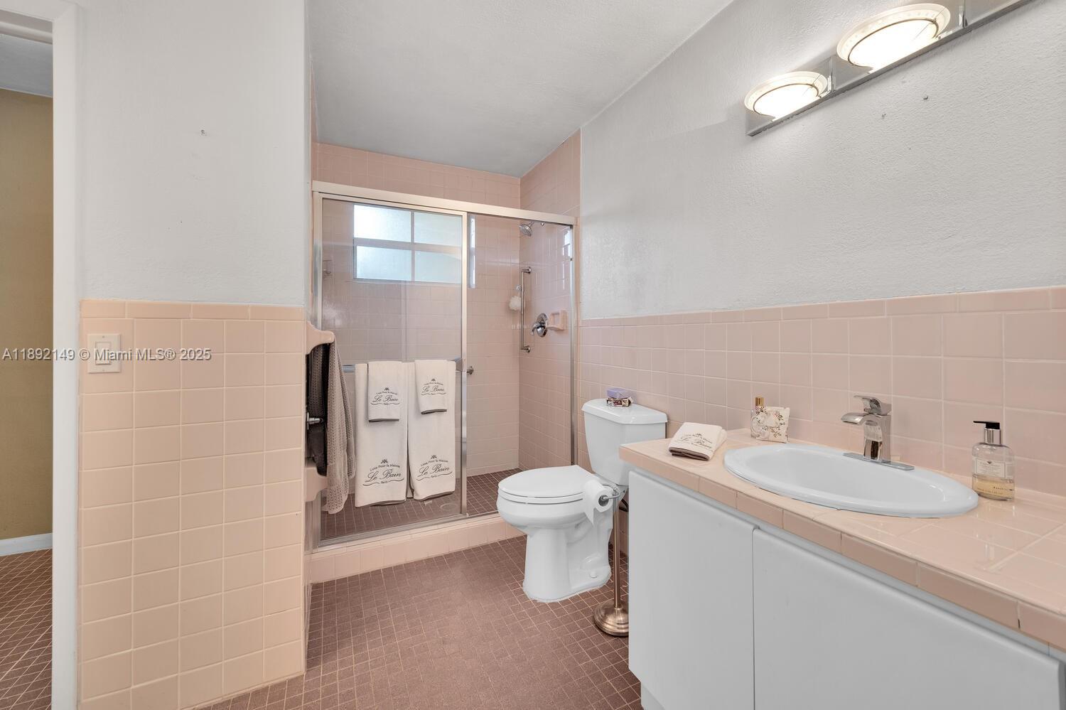 825 El Rado Street Coral Gables, FL 33134 - Photo 28 of 40 a bathroom with a sink a toilet and shower