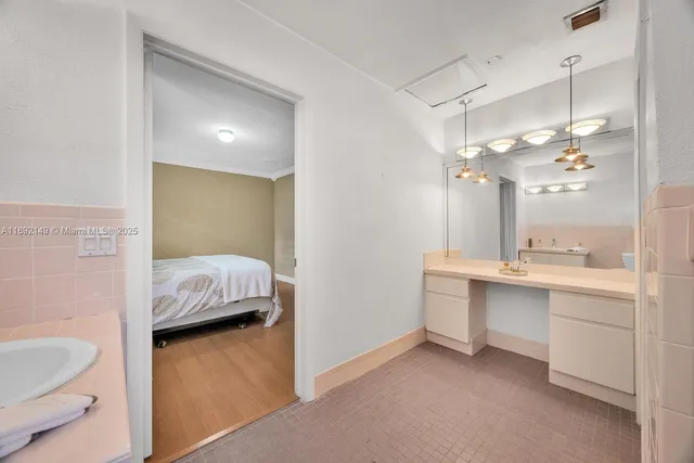 a en suite bathroom with a double vanity sink a toilet a shower and a mirror