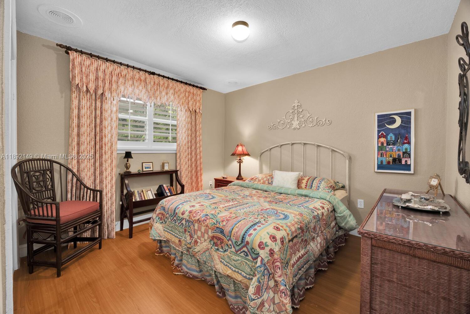 825 El Rado Street Coral Gables, FL 33134 - Photo 30 of 40 a bedroom with a bed and wooden floor