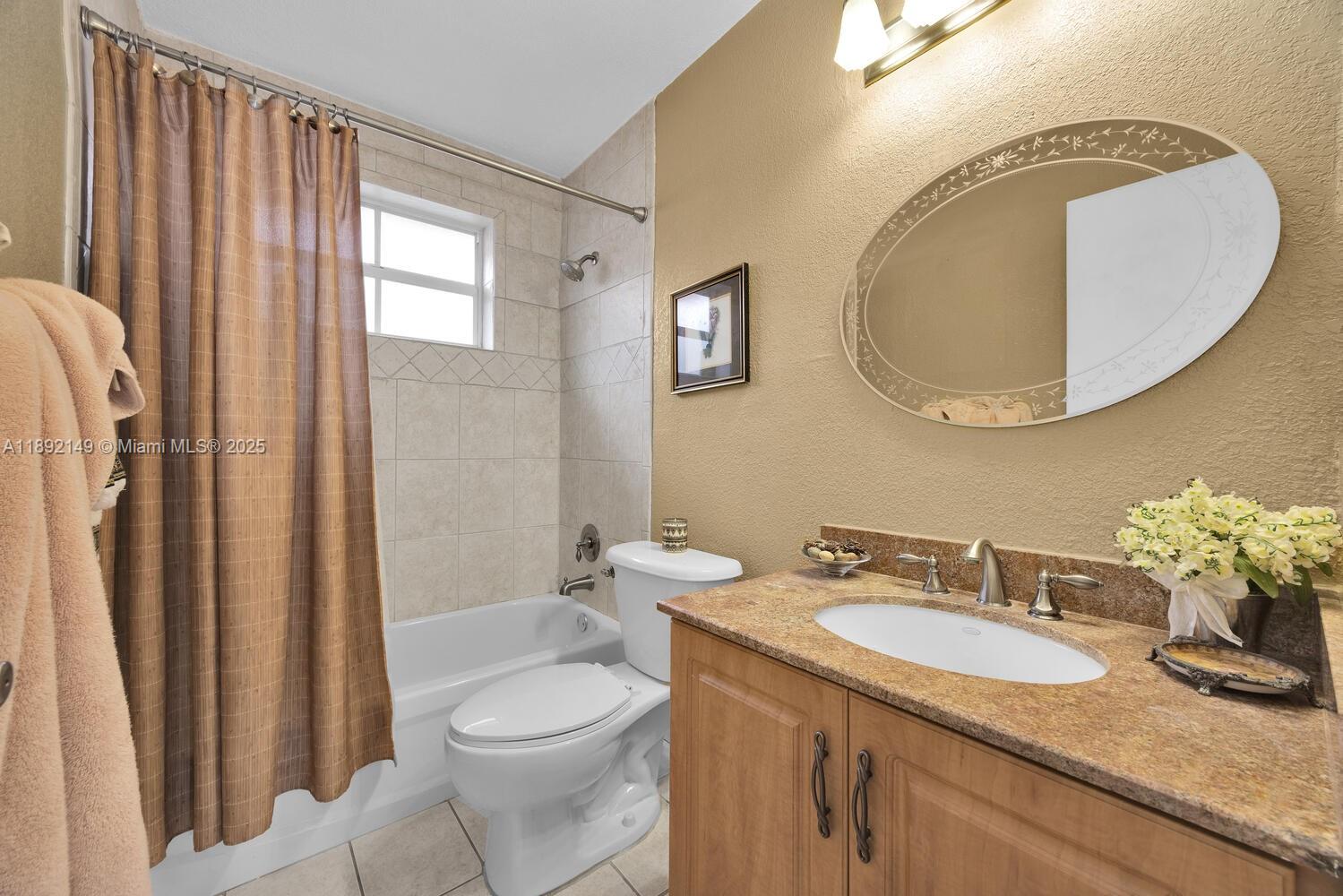 825 El Rado Street Coral Gables, FL 33134 - Photo 32 of 40 a bathroom with a granite countertop toilet sink and mirror