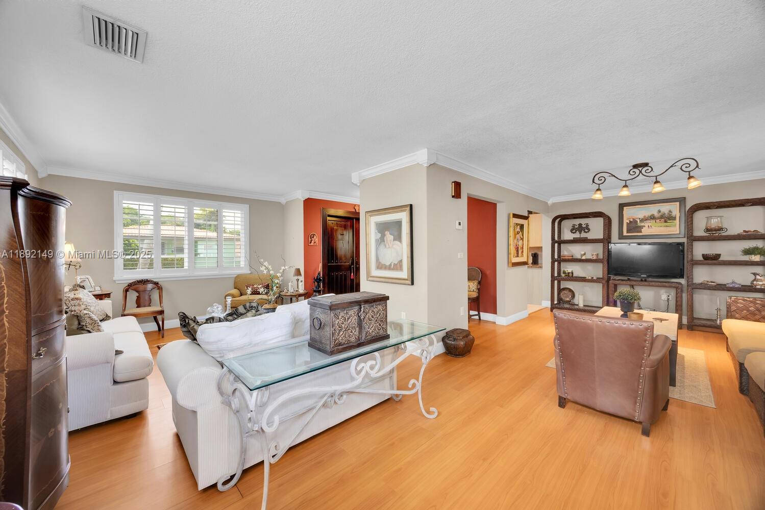 825 El Rado Street Coral Gables, FL 33134 - Photo 8 of 40 a living room with furniture and a flat screen tv