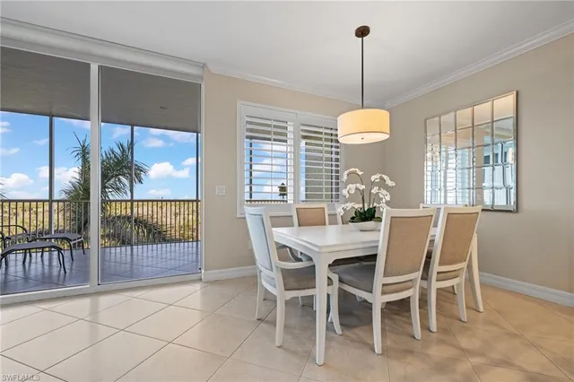 a dining room with furniture a chandelier and wooden floor