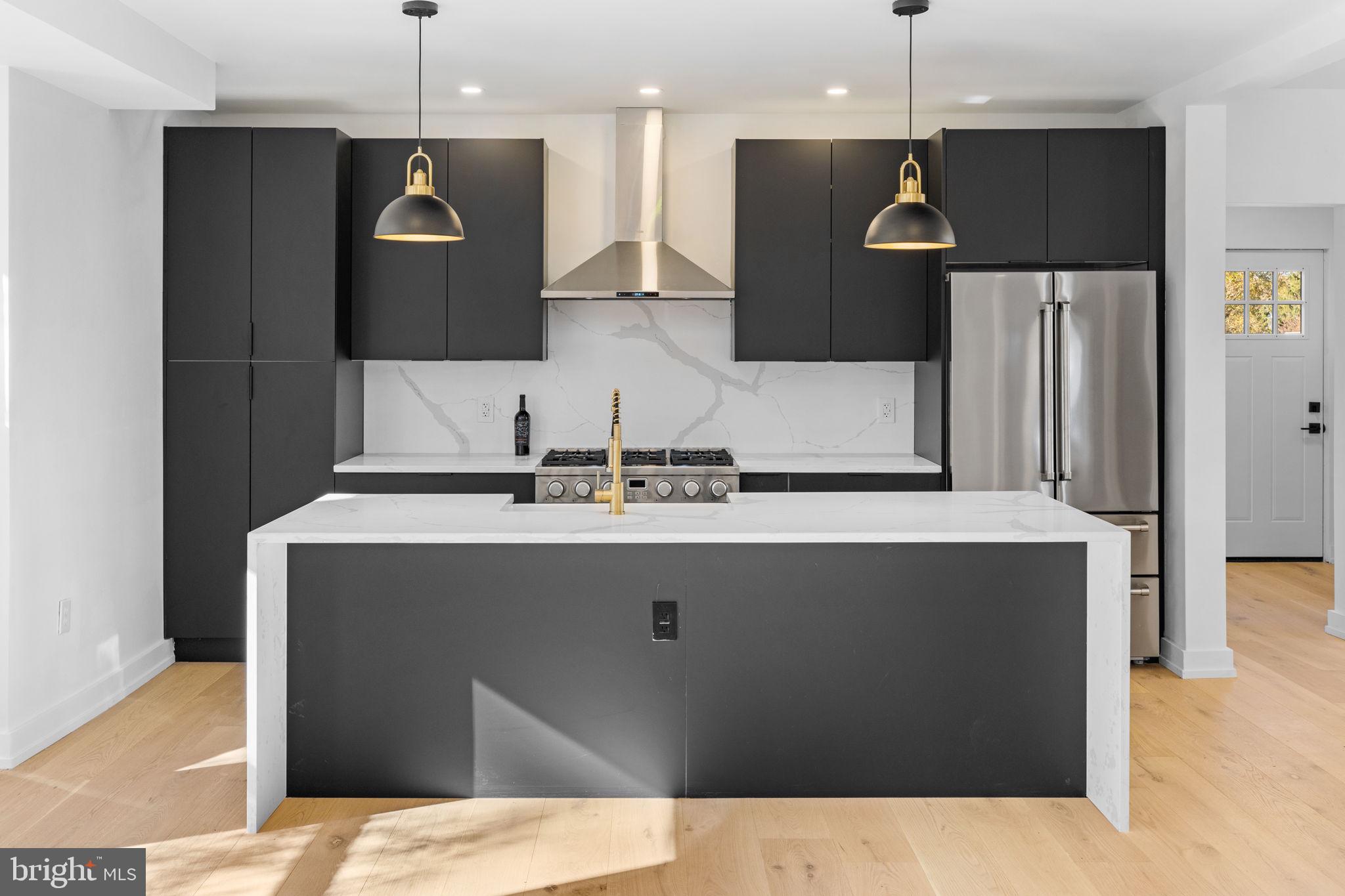 222 Church Road Ardmore, PA 19003 - Photo 16 of 69 a kitchen with a sink a refrigerator and a stove