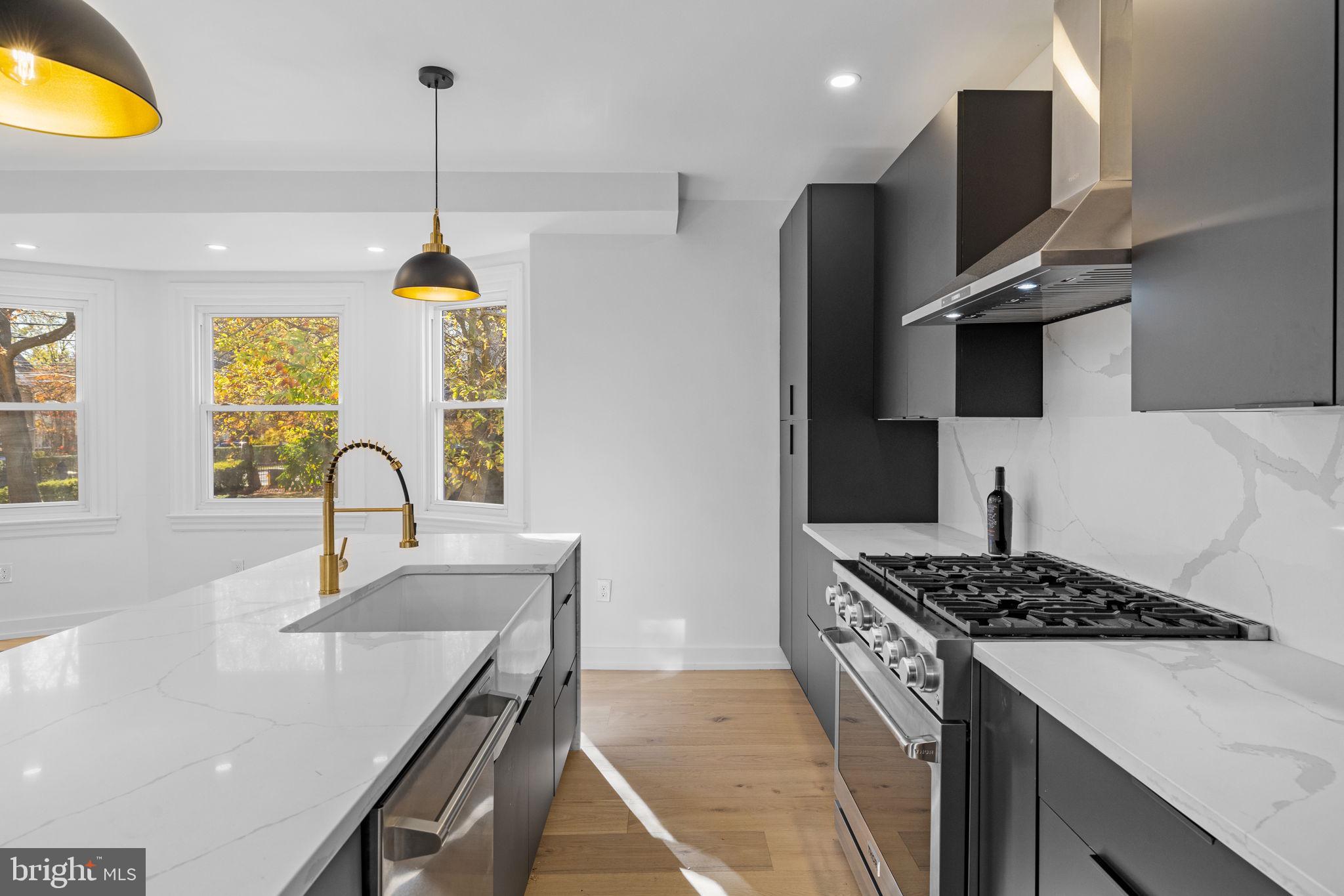 222 Church Road Ardmore, PA 19003 - Photo 24 of 69 a kitchen with stainless steel appliances granite countertop a sink stove and refrigerator