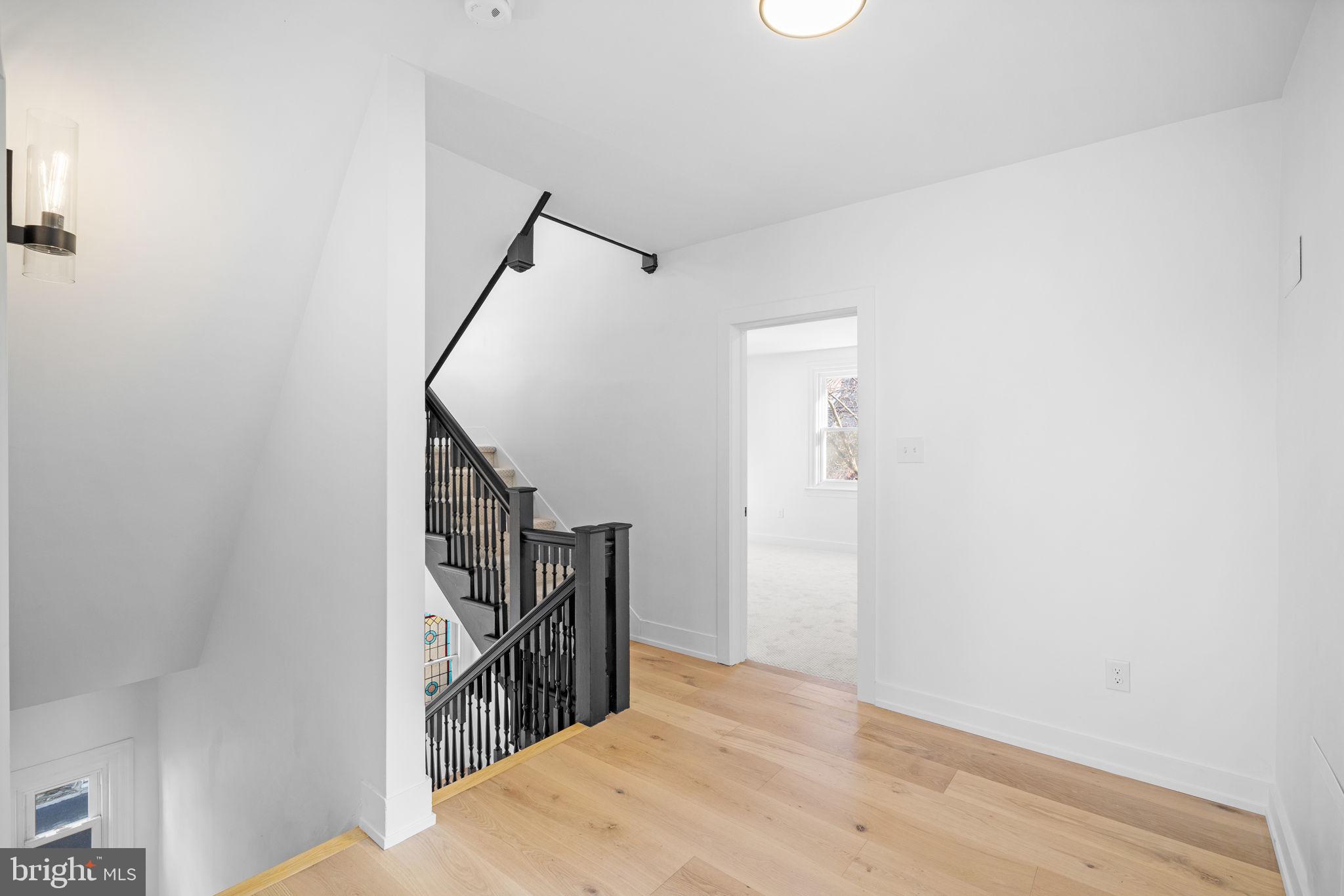 222 Church Road Ardmore, PA 19003 - Photo 37 of 69 a view of hallway with stairs and wooden floor