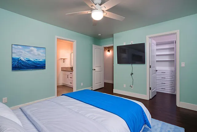 a bedroom with a bed and a chandelier