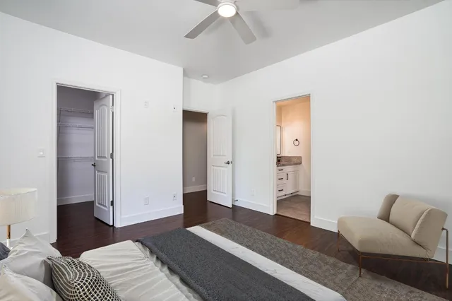 a spacious bedroom with a bed and a couch