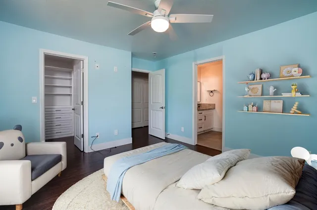 a bedroom with a bed and a chandelier