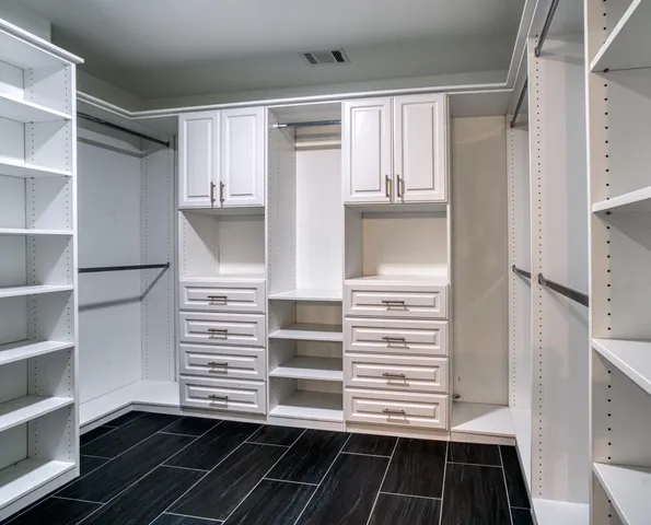 a view of walk in closet and bedroom view