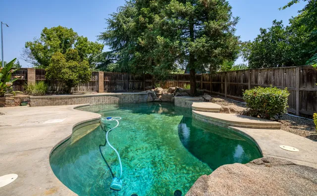 a view of a backyard with plants and outdoor seating
