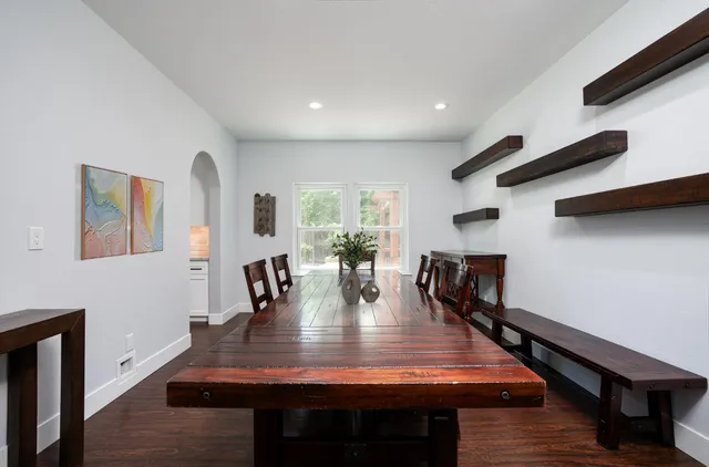 a dining room with furniture and wooden floor