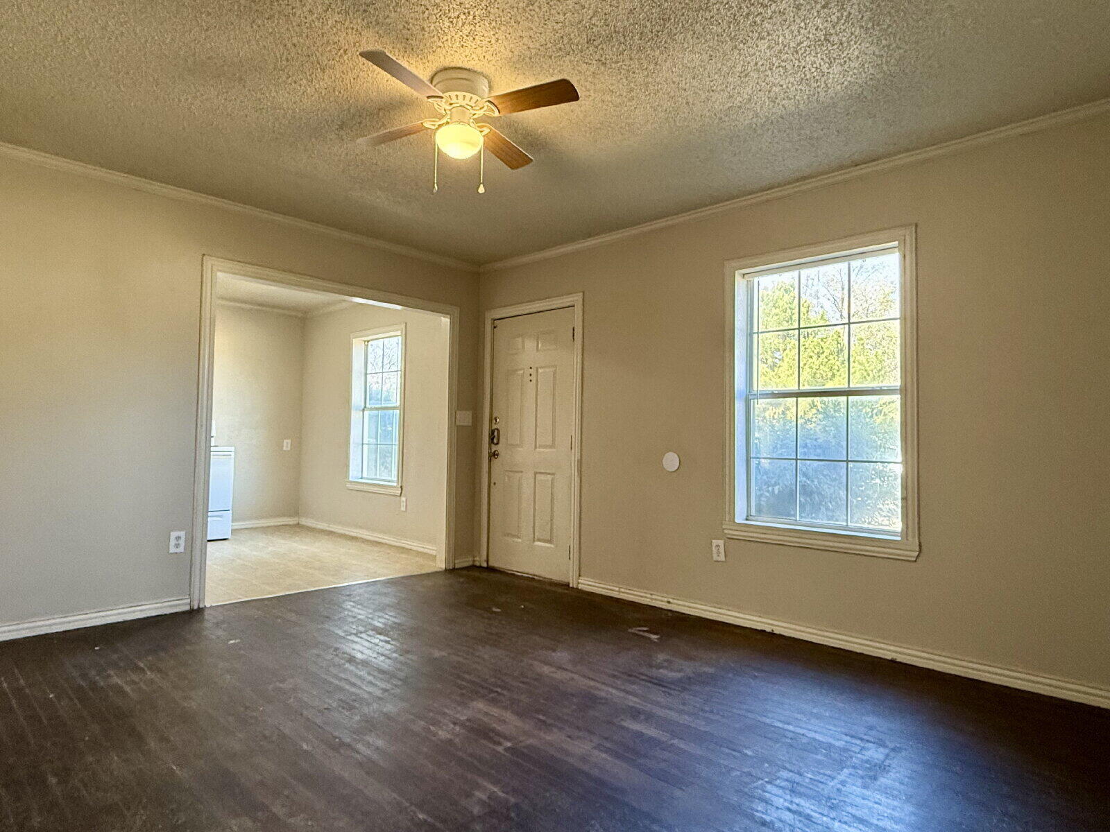 2423 25th Street Lubbock, TX 79411 - Photo 4 of 14 a view of an empty room with a window and wooden floor