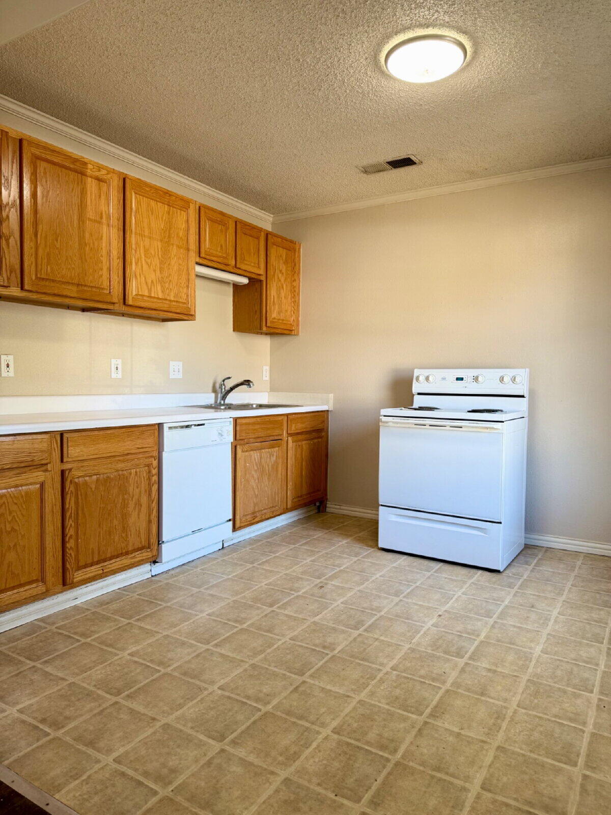 2423 25th Street Lubbock, TX 79411 - Photo 5 of 14 a kitchen with stainless steel appliances granite countertop a sink stove and cabinets