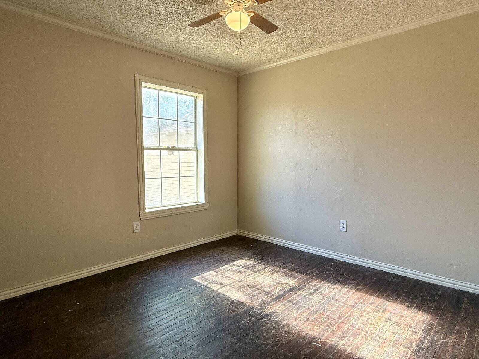 2423 25th Street Lubbock, TX 79411 - Photo 7 of 14 a view of empty room with wooden floor and fan