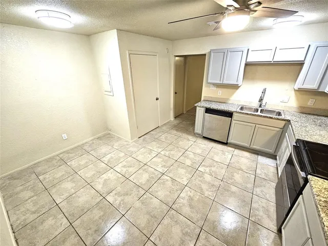 a kitchen with a sink cabinets and appliances