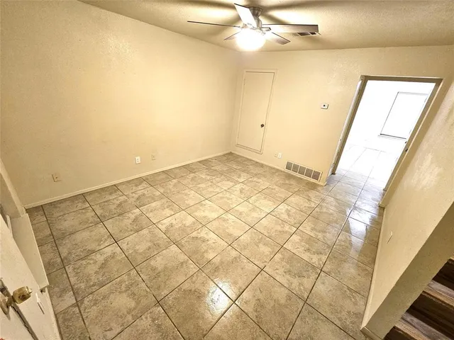a view of a room with white walls and tiles