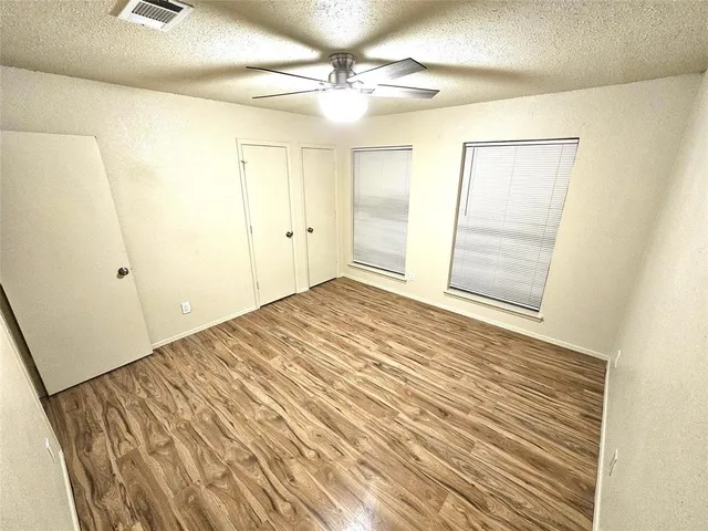 a view of a room with wooden floor