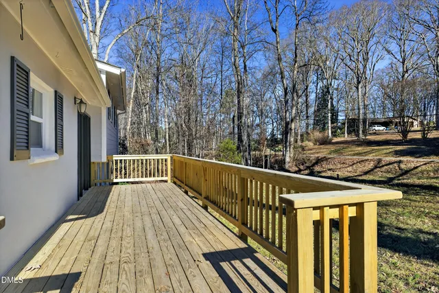 a view of balcony with wooden floor and fence