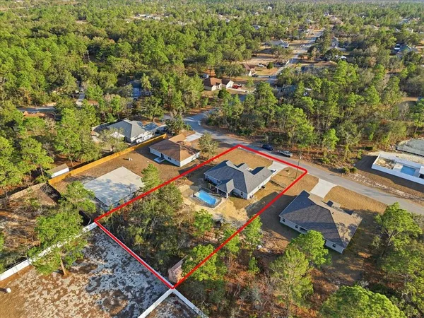 an aerial view of residential houses with outdoor space