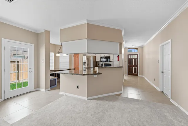 a view of kitchen with refrigerator and window