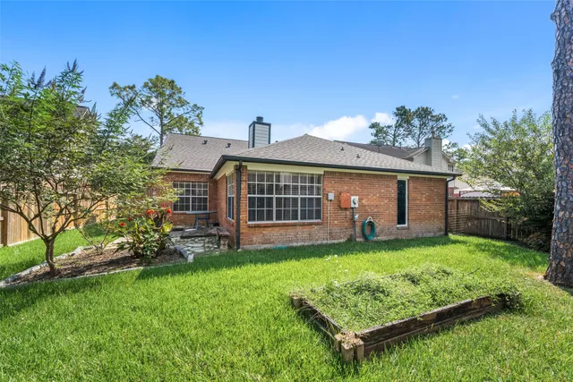 a view of a house with a yard and sitting area
