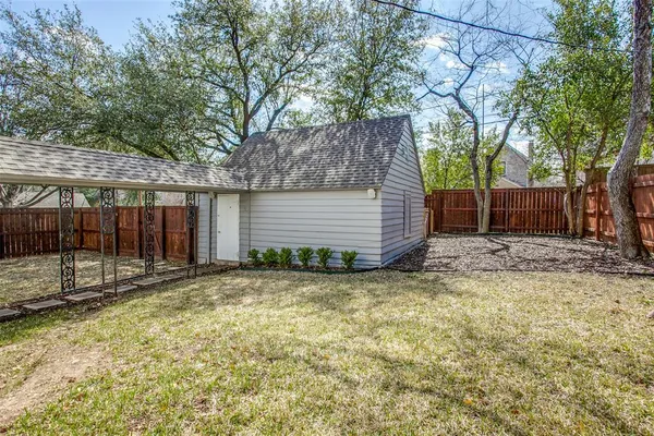 a view of a backyard with a tree