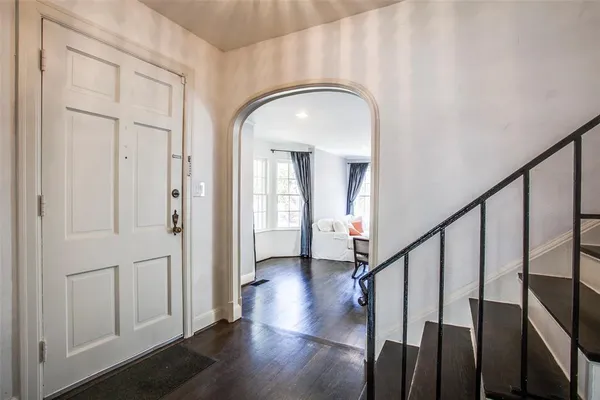 a view of entryway with wooden floor and stairs