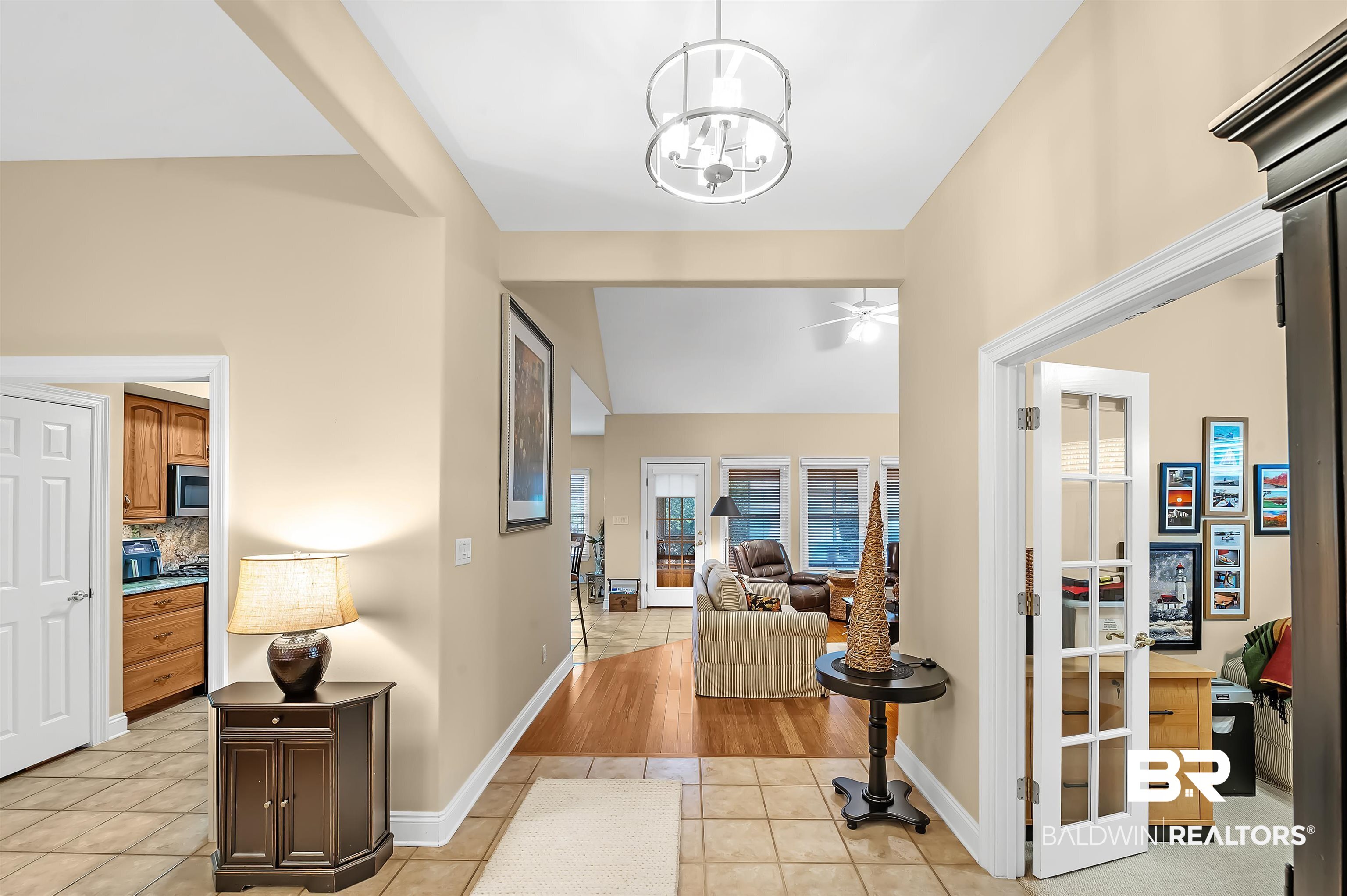 22726 Inverness Way Foley, AL 36535 - Photo 14 of 51 Corridor with light tile patterned floors and a notable chandelier