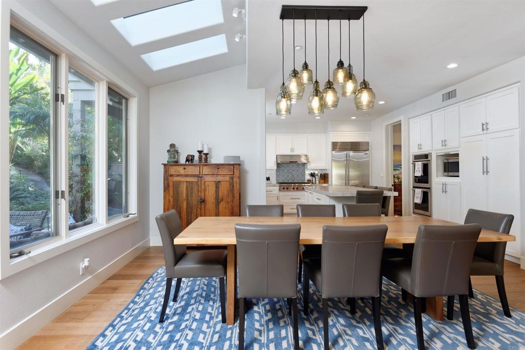 1739 Sienna Canyon Drive Encinitas, CA 92024 - Photo 12 of 29 a view of a dining room with furniture a chandelier and wooden floor