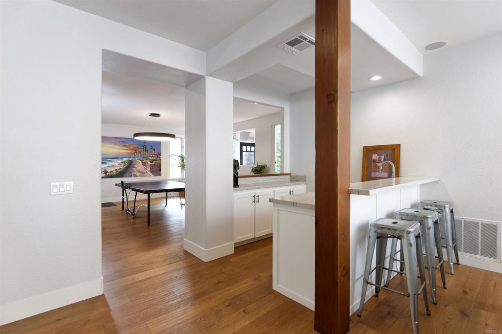1739 Sienna Canyon Drive Encinitas, CA 92024 - Photo 14 of 29 a view of dining room with kitchen island wooden floor and living room