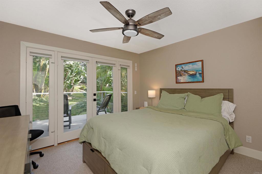 1739 Sienna Canyon Drive Encinitas, CA 92024 - Photo 20 of 29 a bedroom with a large bed and a large window
