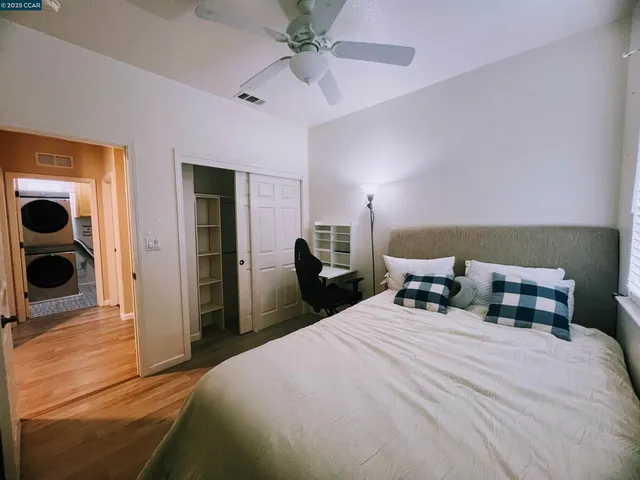 a bedroom with a bed tv and table